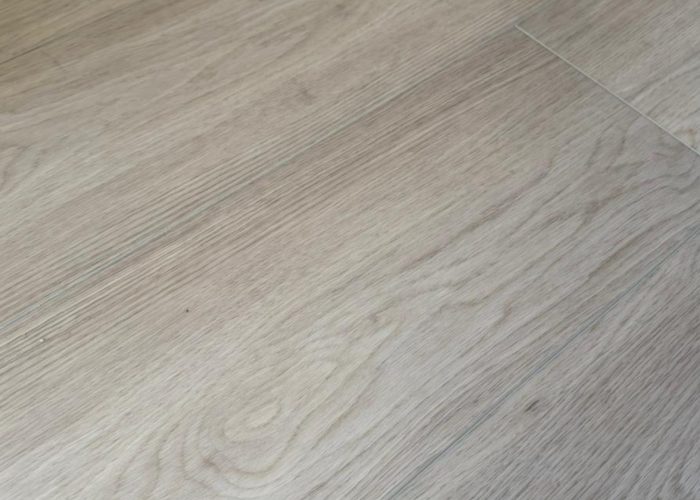 About Us Close-up texture detail of oak-look vinyl flooring